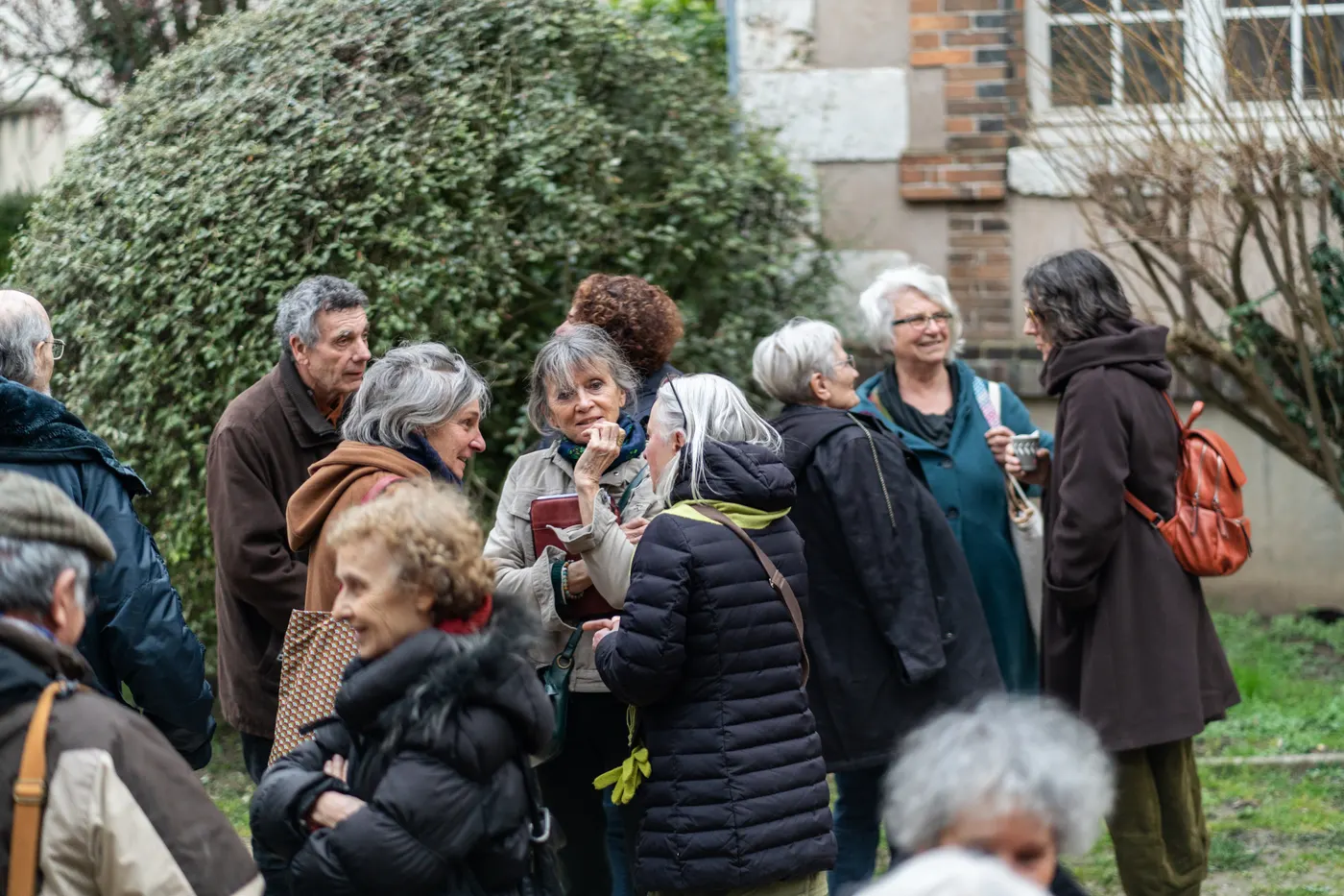 Groupe de personnes discutant dans un jardin